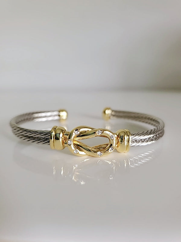 Gold and silver bracelet on a white background