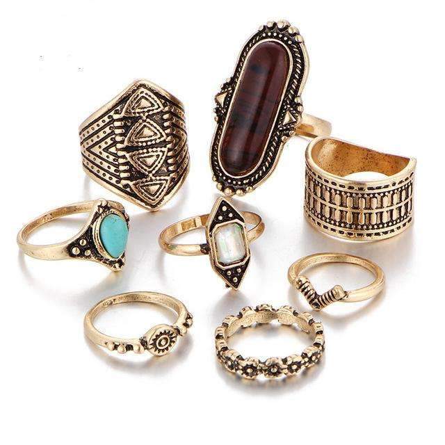 Collection of gold and stone rings on a white background