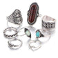 Set of silver rings with various gemstones on a white background