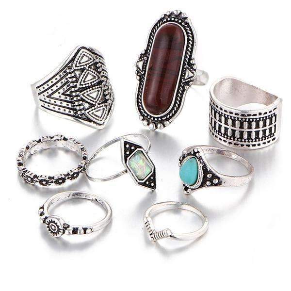Set of silver rings with various gemstones on a white background