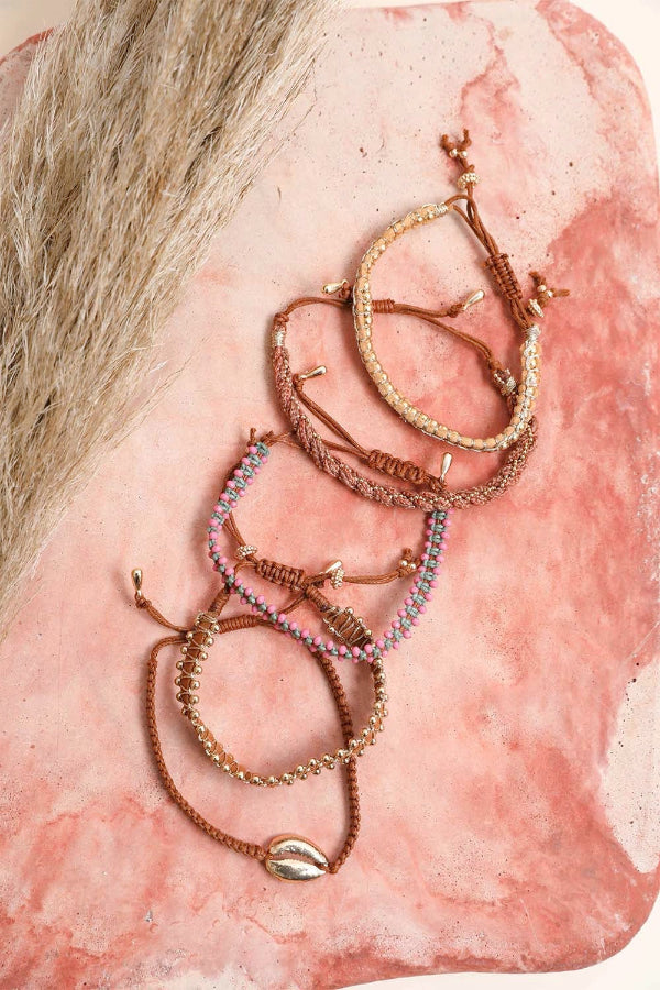 Gold hoop earrings on a pink stone background